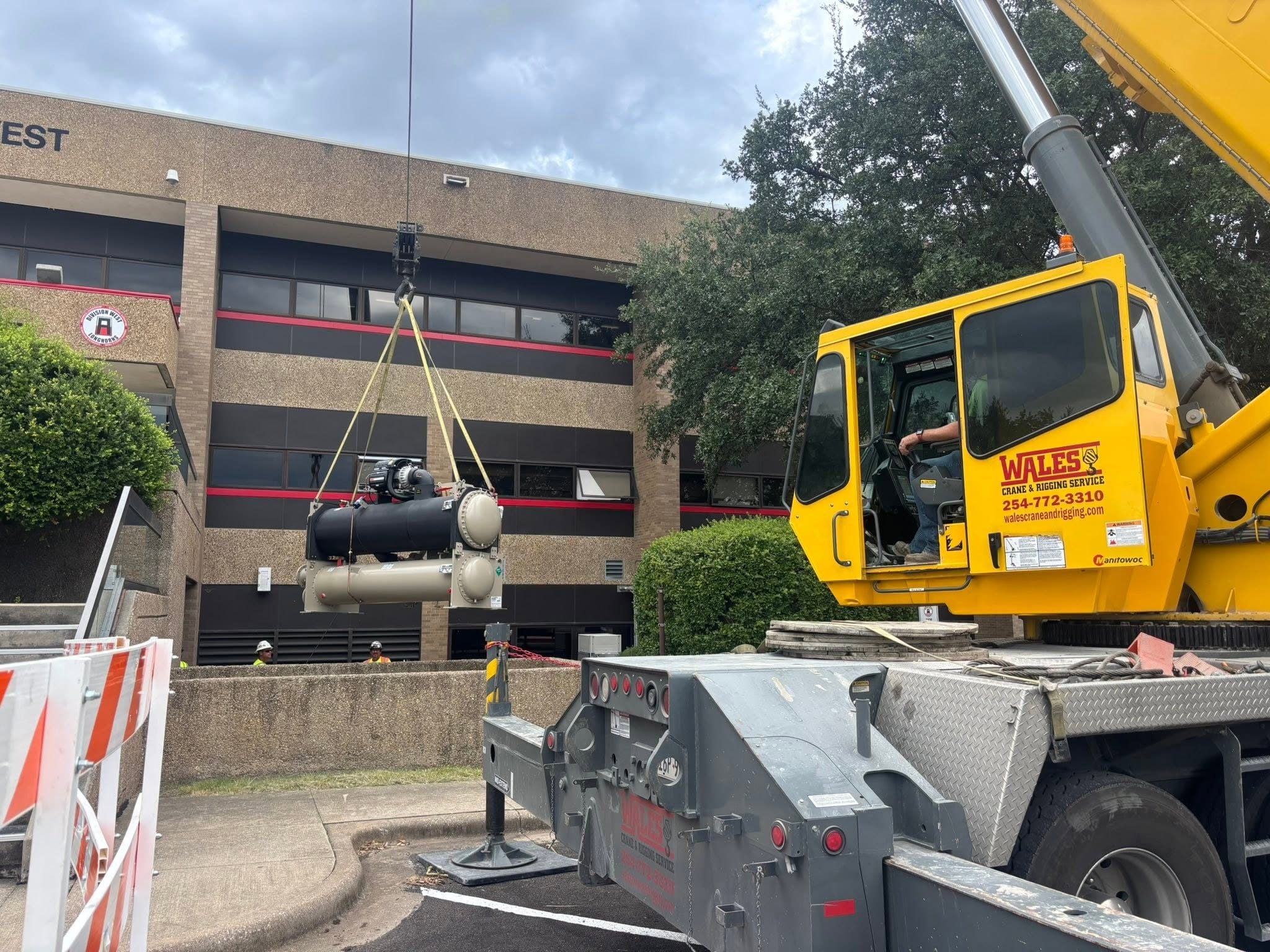 Commercial mechanical equipment being set beside a Central Texas facility