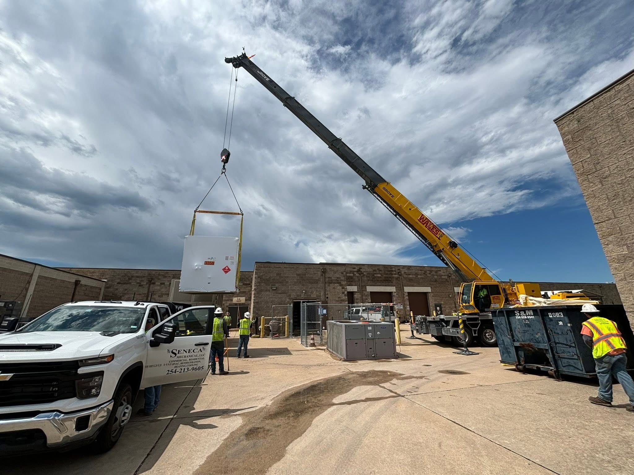 Mechanical equipment being guided into place during a crane set
