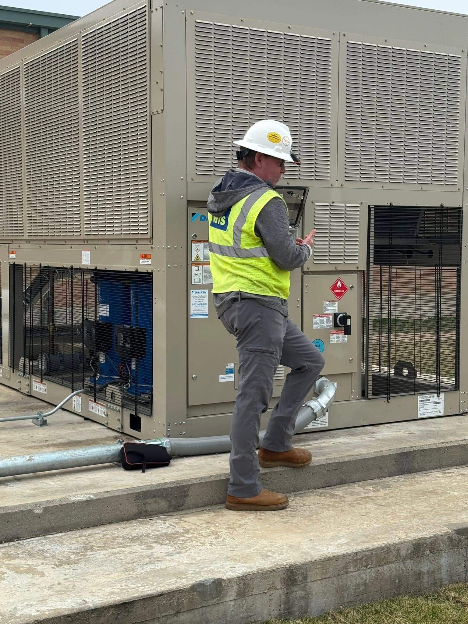 Seneca technician servicing outdoor mechanical equipment